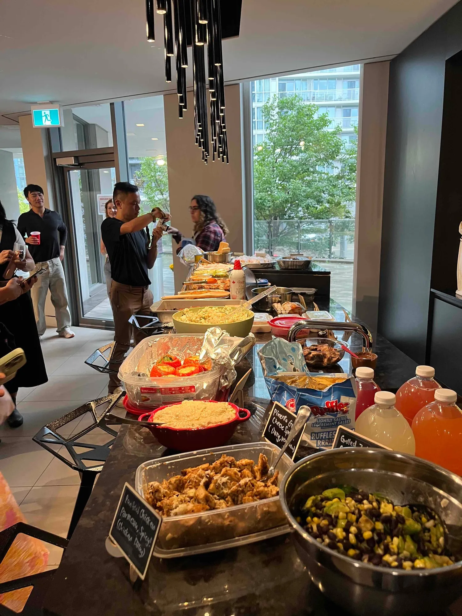 The spread running down the counter at the August Sauté Sundays, a chalkboard label in front of every dish