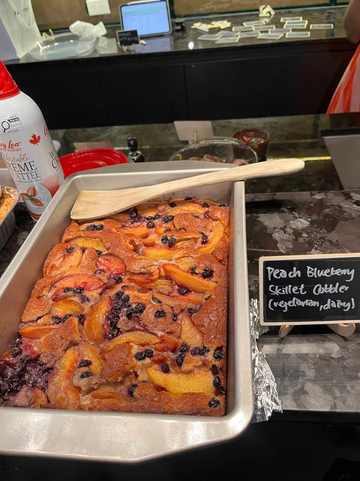 A peach and blueberry skillet cobbler in its baking tray