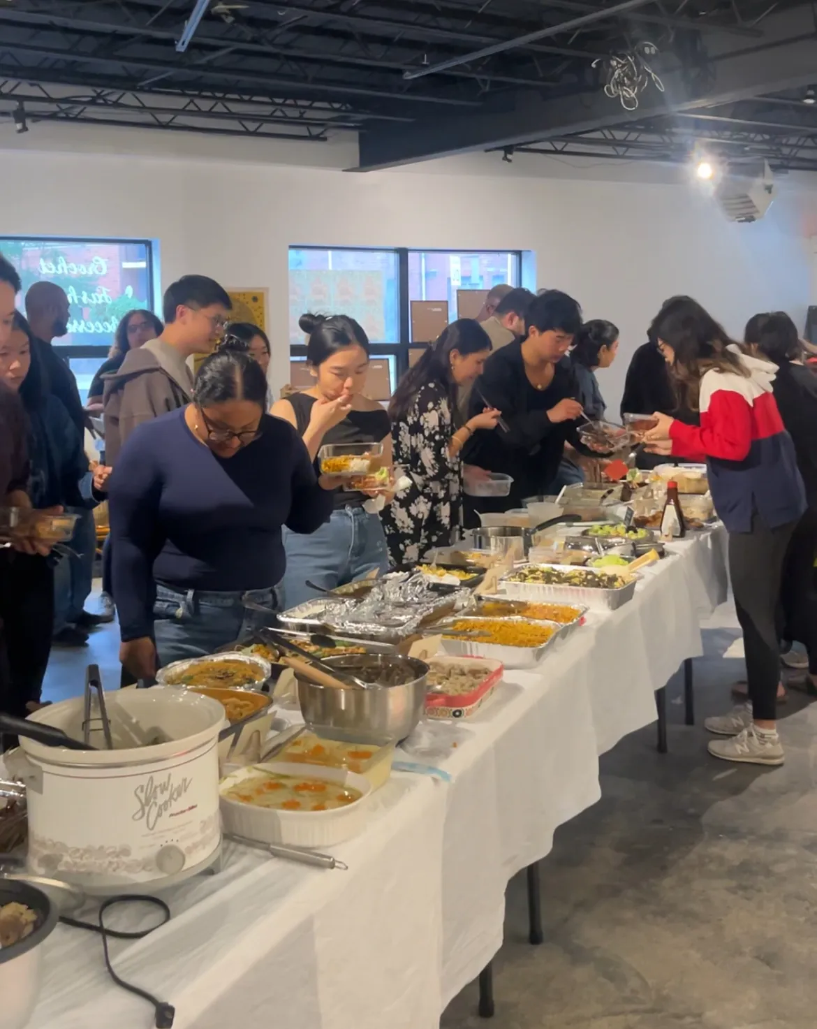 The table at Sauté Sundays September night, food running the length of it while guests serve themselves
